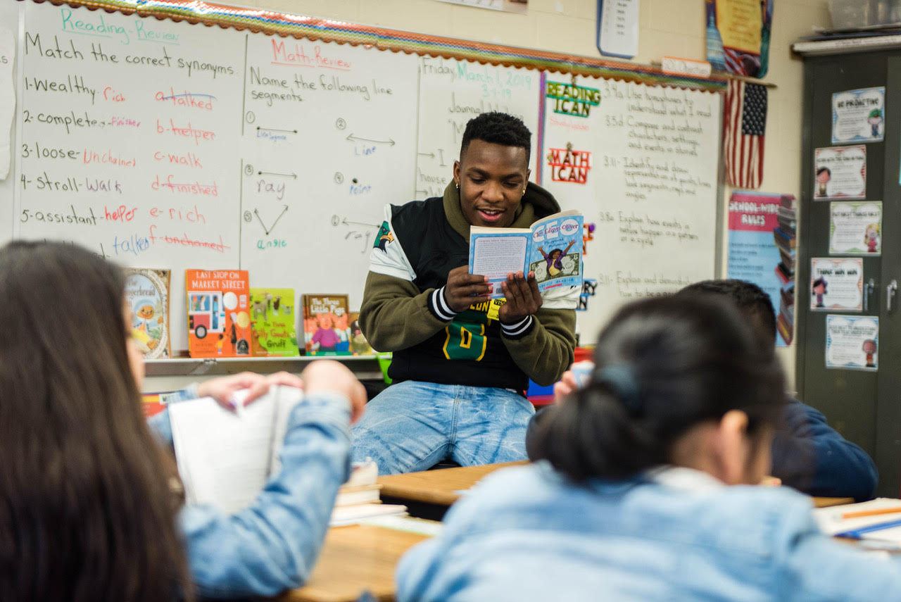 A Hermitage H.S. football player reads to students to kick off OROB in Richmond, March 2019