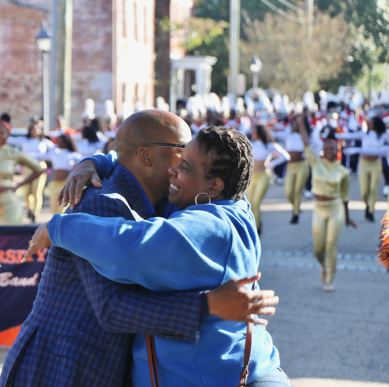 President Abdullah stops his parade march and gives hug to VSU's Stephanie McNeil